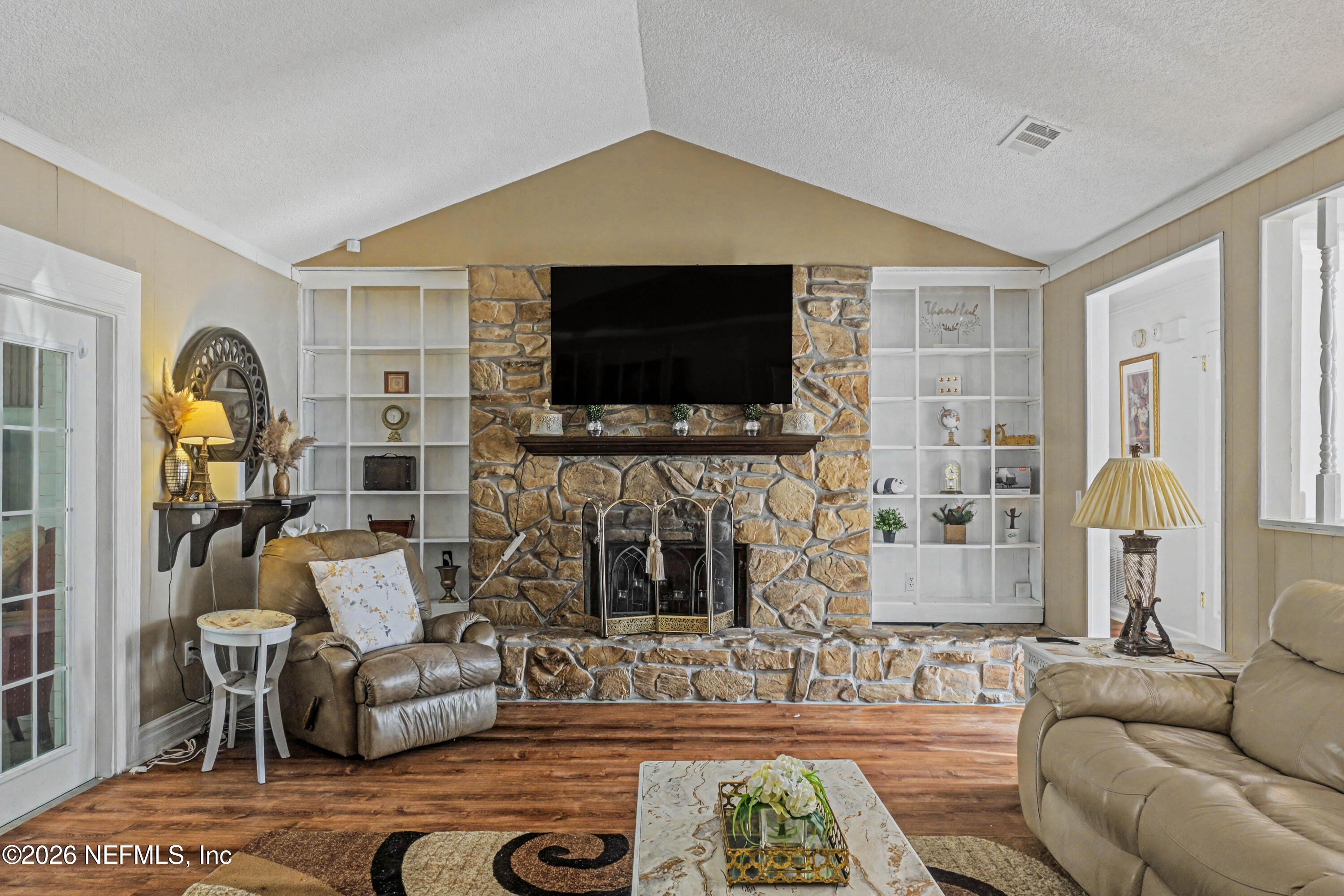 1502 Pointer Drive West Jacksonville, FL 32221 - Photo 2 of 33 a living room with furniture a flat screen tv and a fireplace