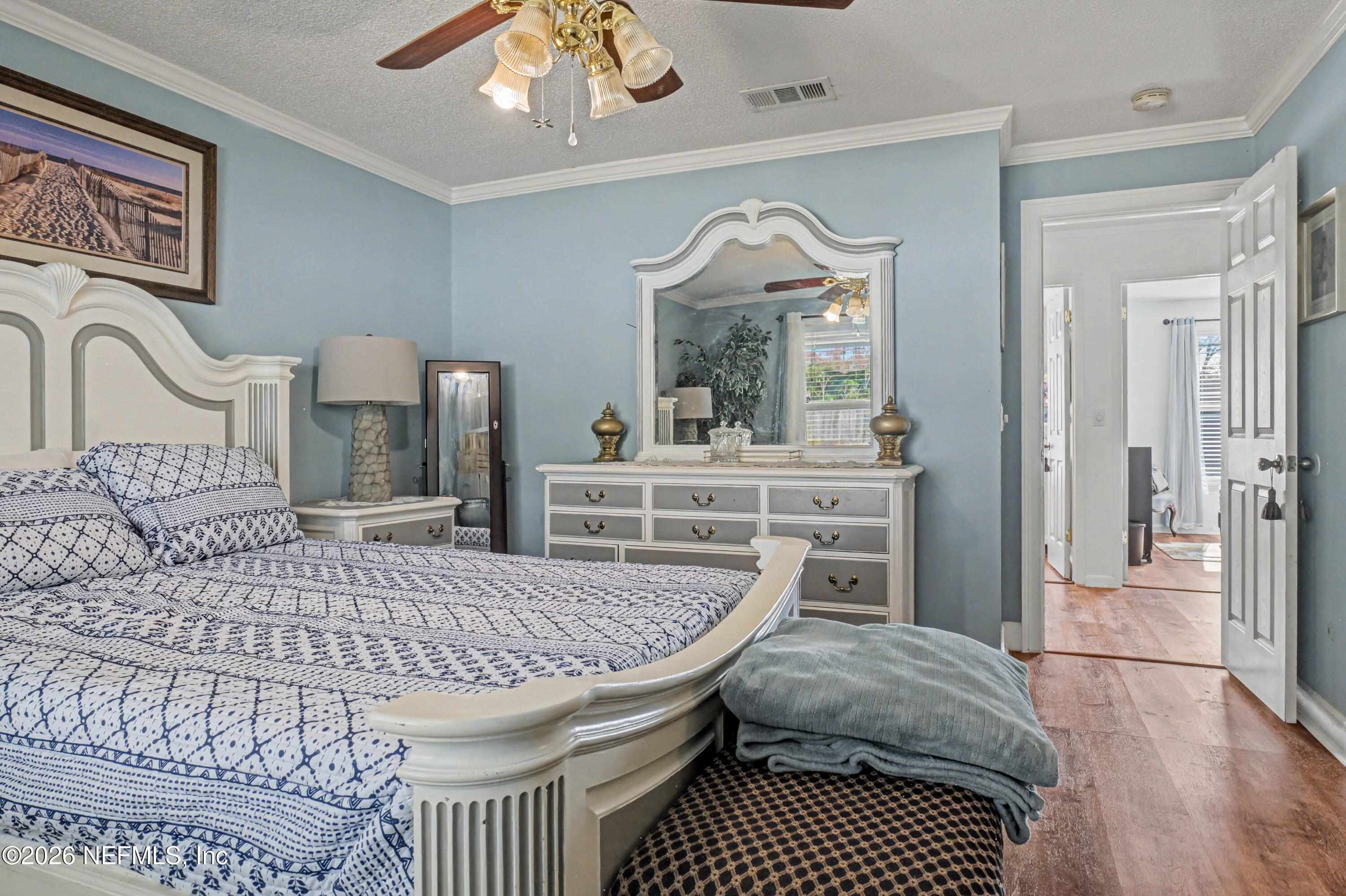 1502 Pointer Drive West Jacksonville, FL 32221 - Photo 24 of 33 a bedroom with a bed a chandelier and dresser