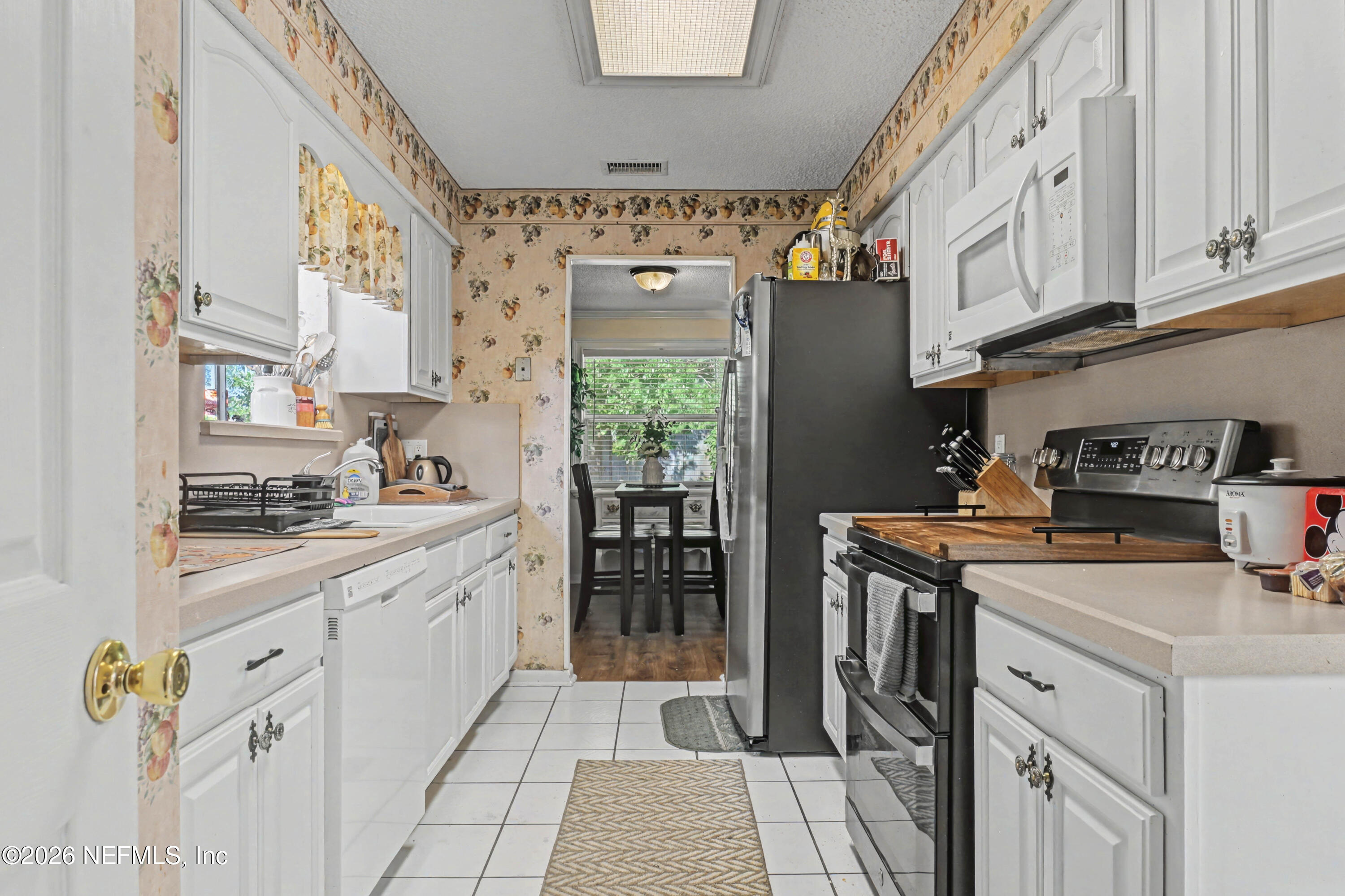 1502 Pointer Drive West Jacksonville, FL 32221 - Photo 8 of 33 a kitchen with stainless steel appliances granite countertop a stove a sink and a refrigerator