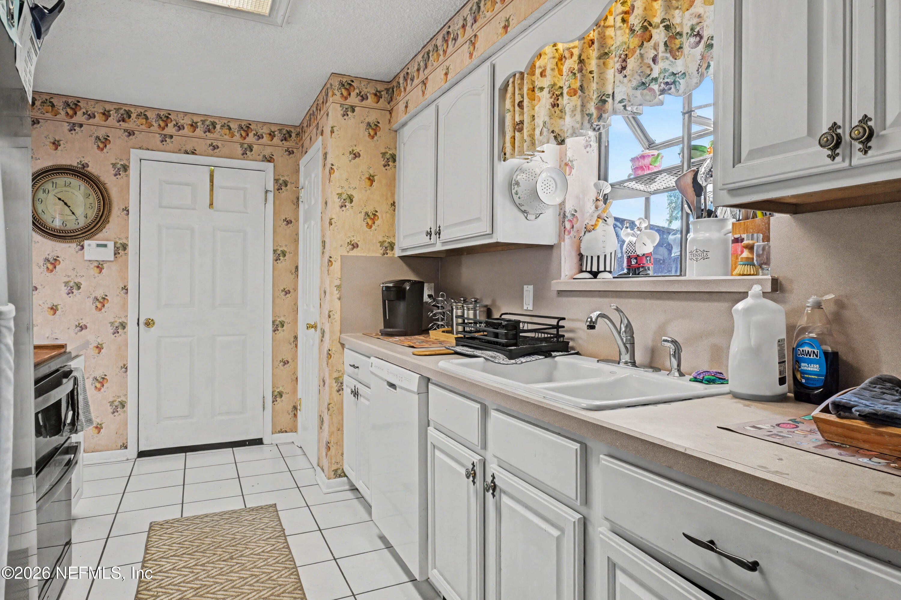 1502 Pointer Drive West Jacksonville, FL 32221 - Photo 10 of 33 a kitchen with stainless steel appliances granite countertop a sink a stove a washer and dryer