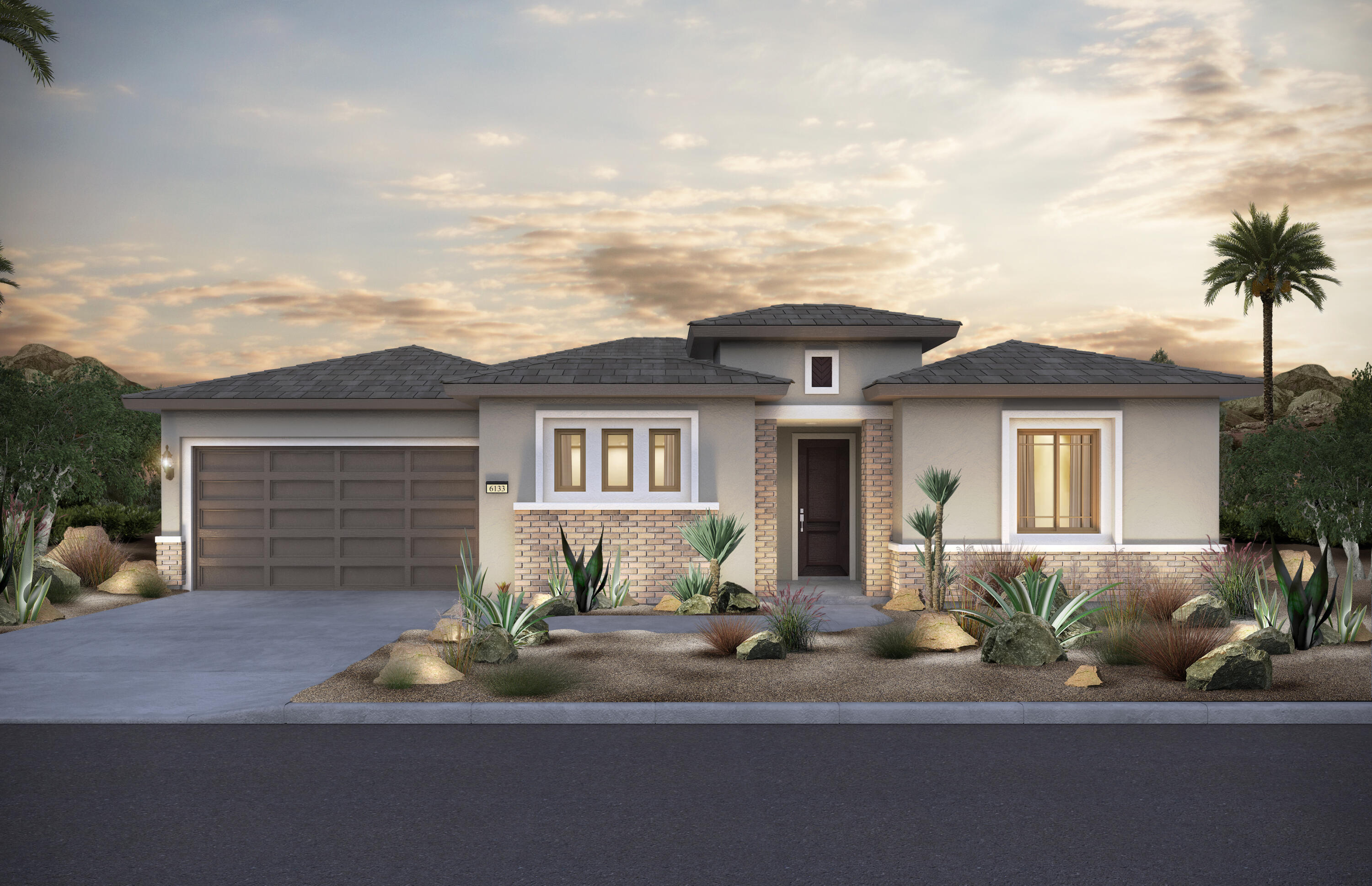 a front view of a house with a yard and potted plants