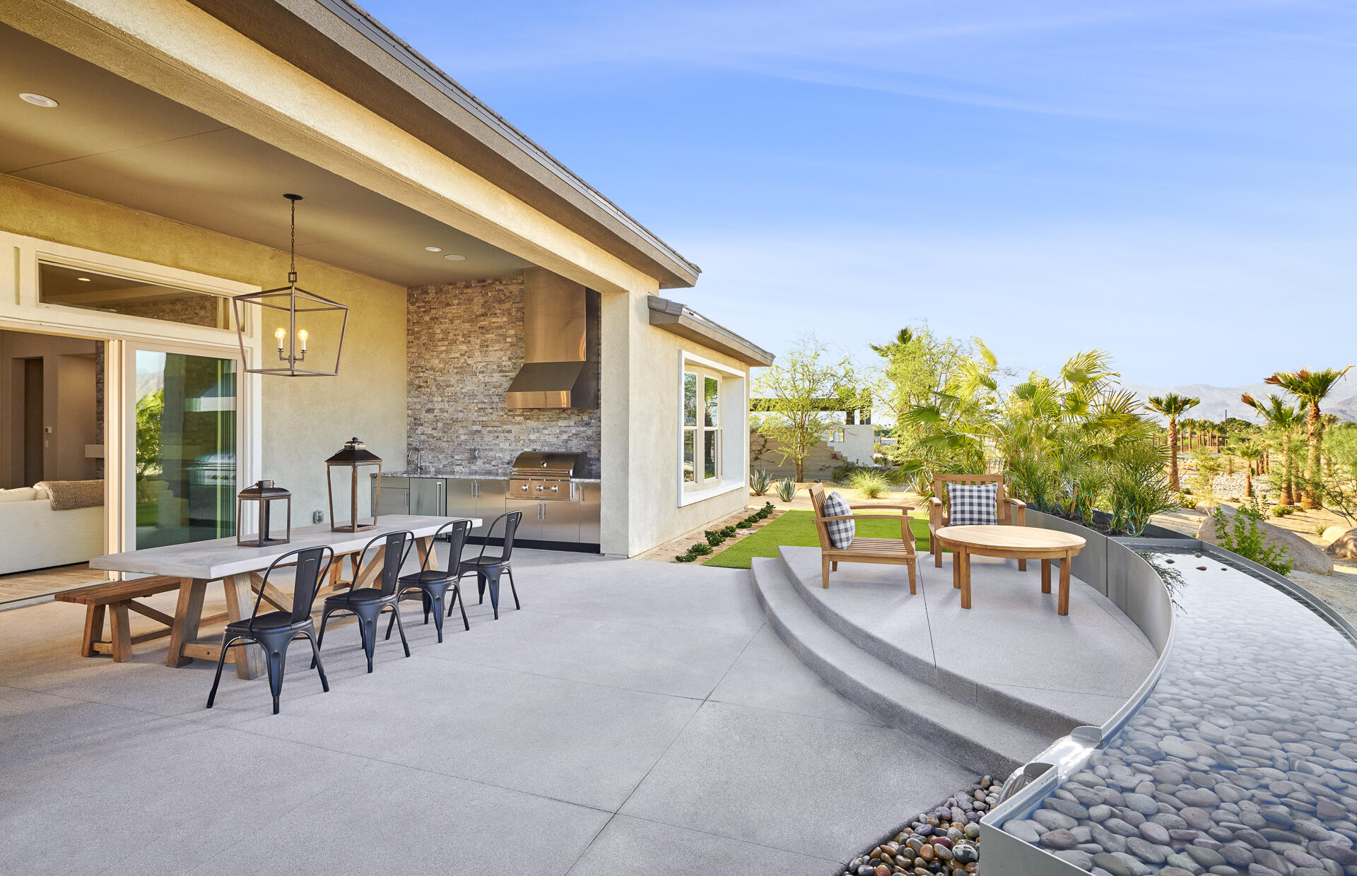 21 Chablis Rancho Mirage, CA 92270 - Photo 3 of 17 a view of a patio with a table and chairs and potted plants