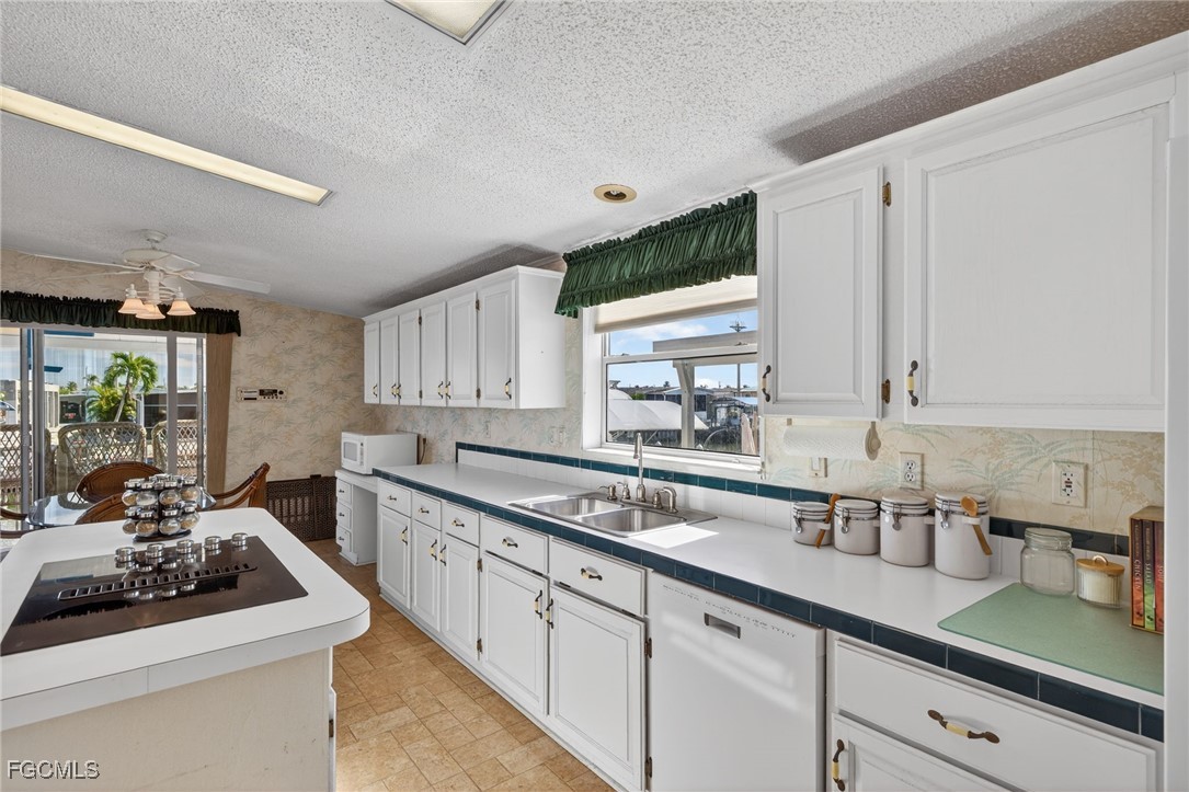 3088 Skipper Lane St. James City, FL 33956 - Photo 11 of 43 a kitchen with sink a stove and cabinets