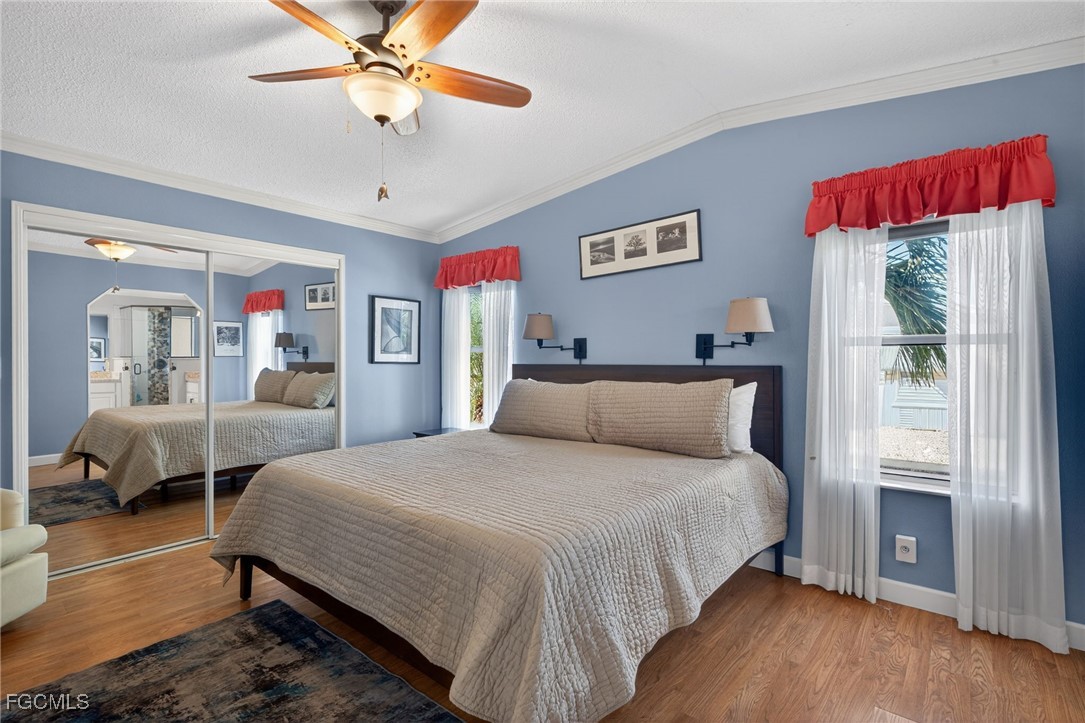 3088 Skipper Lane St. James City, FL 33956 - Photo 20 of 43 a bedroom with a bed and wooden floor