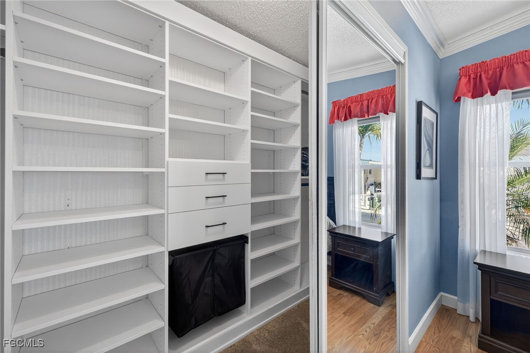 3088 Skipper Lane St. James City, FL 33956 - Photo 21 of 43 a view of walk in closet with clothes and shoes