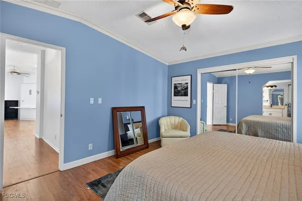 a bedroom with a large bed and a chandelier