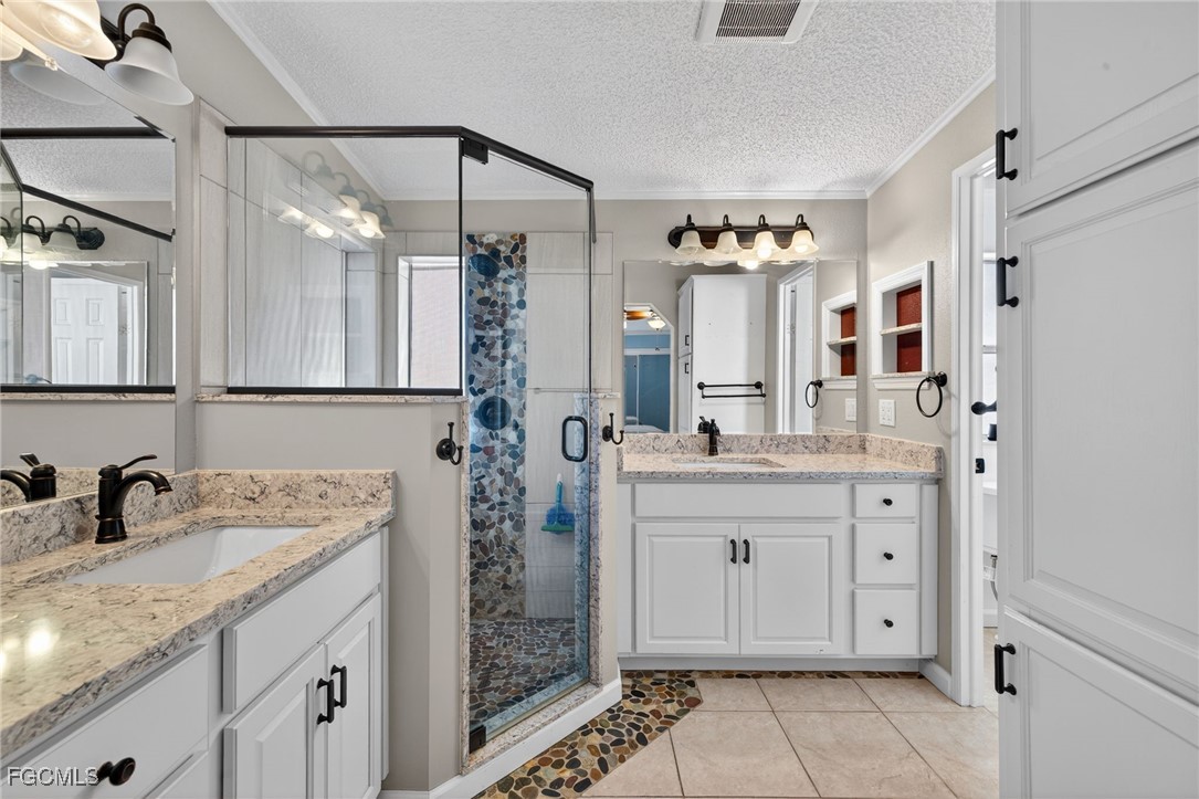 3088 Skipper Lane St. James City, FL 33956 - Photo 26 of 43 a bathroom with a granite countertop sink a mirror and shower