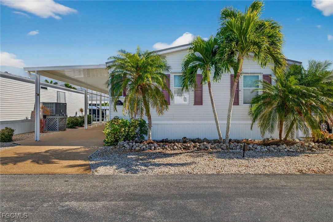3088 Skipper Lane St. James City, FL 33956 - Photo 37 of 43 a couple of palm trees in front of house