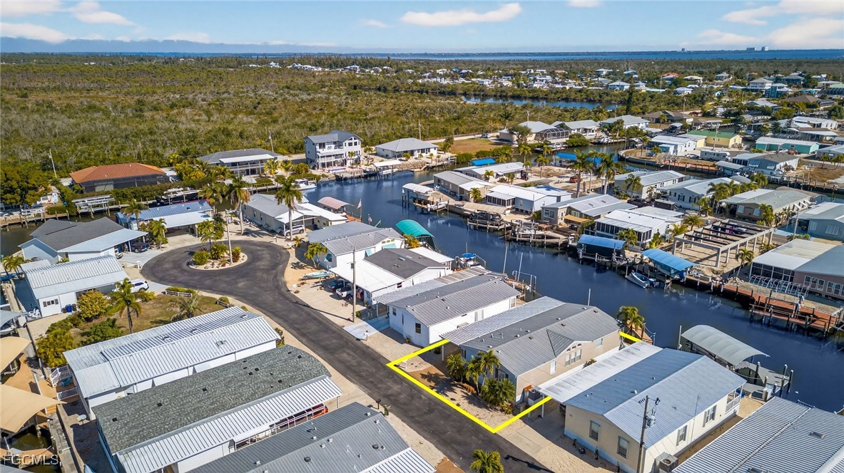 3088 Skipper Lane St. James City, FL 33956 - Photo 39 of 43 an aerial view of a city with lots of residential buildings and ocean view in back
