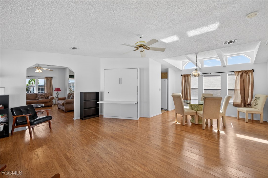 3088 Skipper Lane St. James City, FL 33956 - Photo 5 of 43 a living room with furniture dining table and wooden floor