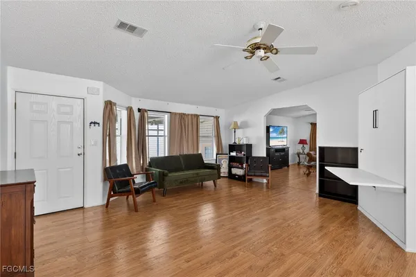 a living room with furniture and wooden floor