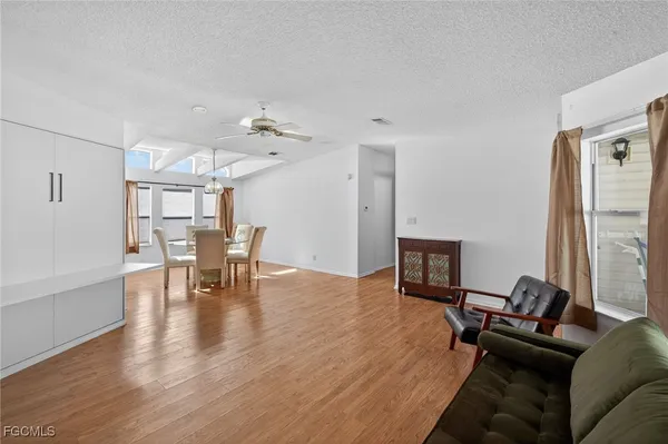 a view of a dining room with furniture wooden floor and chandelier