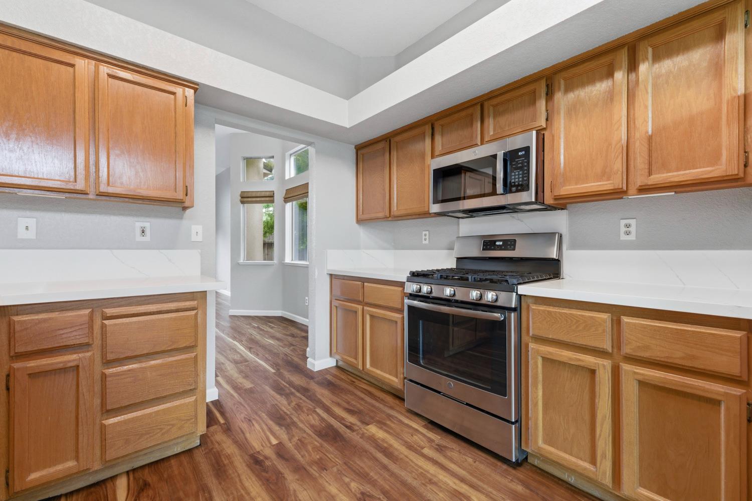 969 Colson Way Galt, CA 95632 - Photo 13 of 38 a kitchen with stainless steel appliances granite countertop a stove and a sink