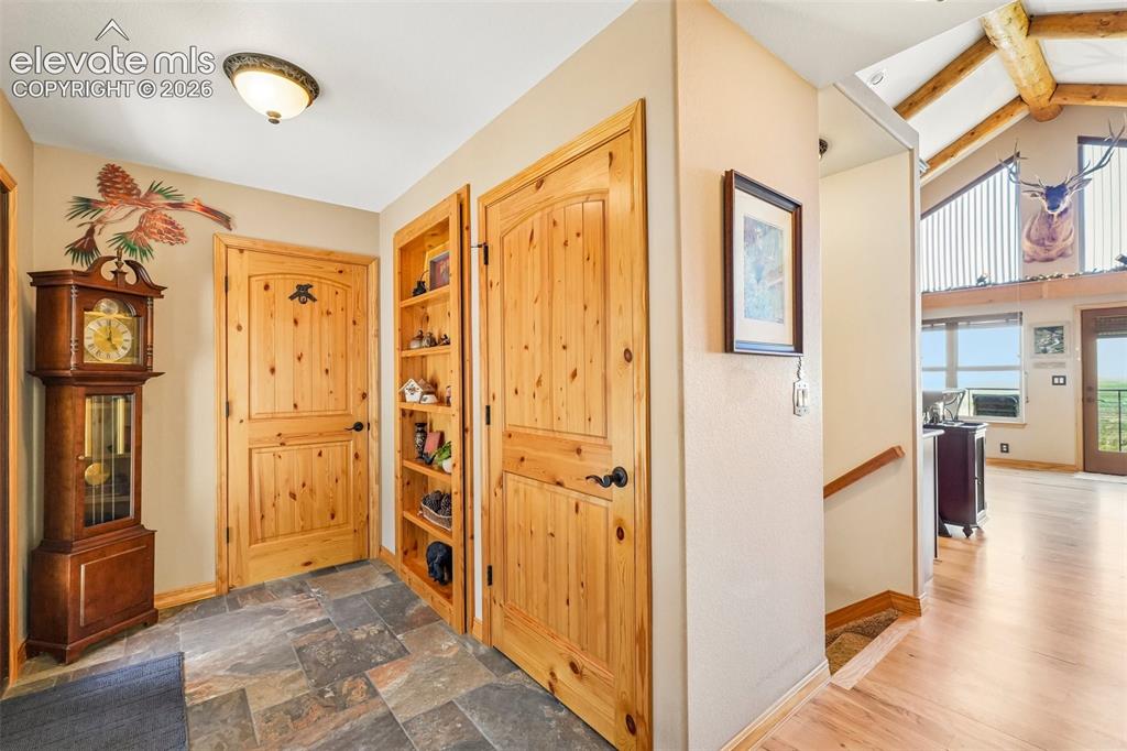 858 Oak Ridge Road Manitou Springs, CO 80829 - Photo 6 of 50 Grand foyer with knotty pine doors and trim