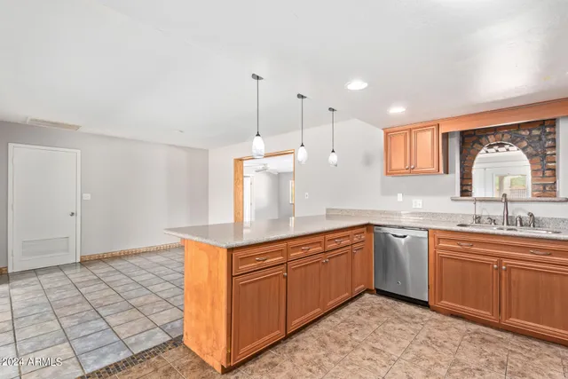 a kitchen with stainless steel appliances granite countertop a refrigerator sink and cabinets