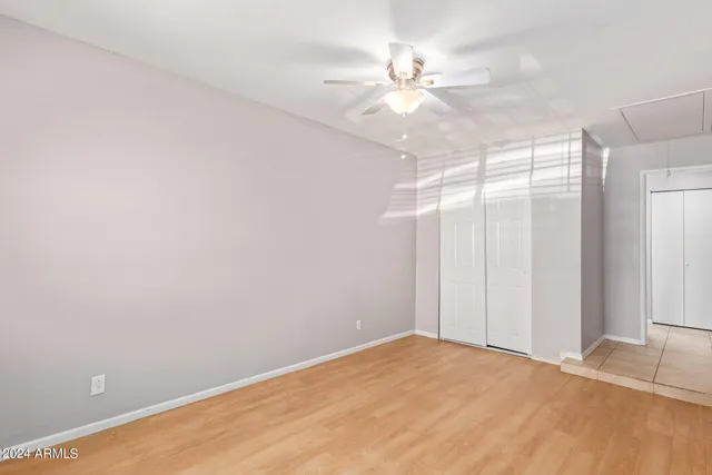 a view of a room with a ceiling fan and a window