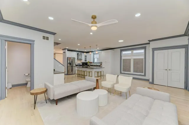 a bathroom with a granite countertop sink mirror vanity bathtub and a toilet