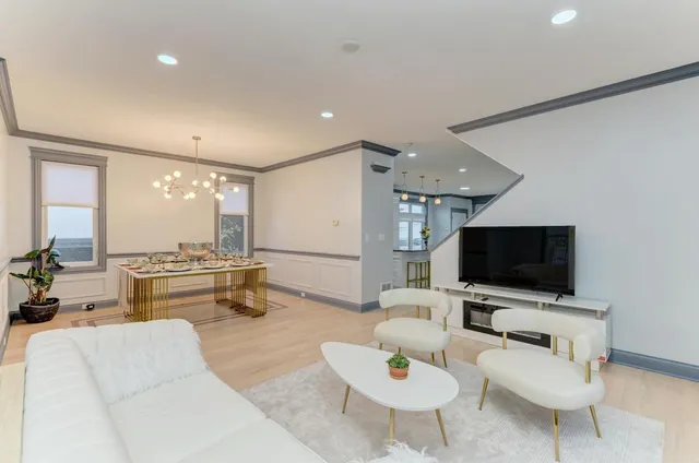 a kitchen with stainless steel appliances granite countertop a sink a stove and a refrigerator