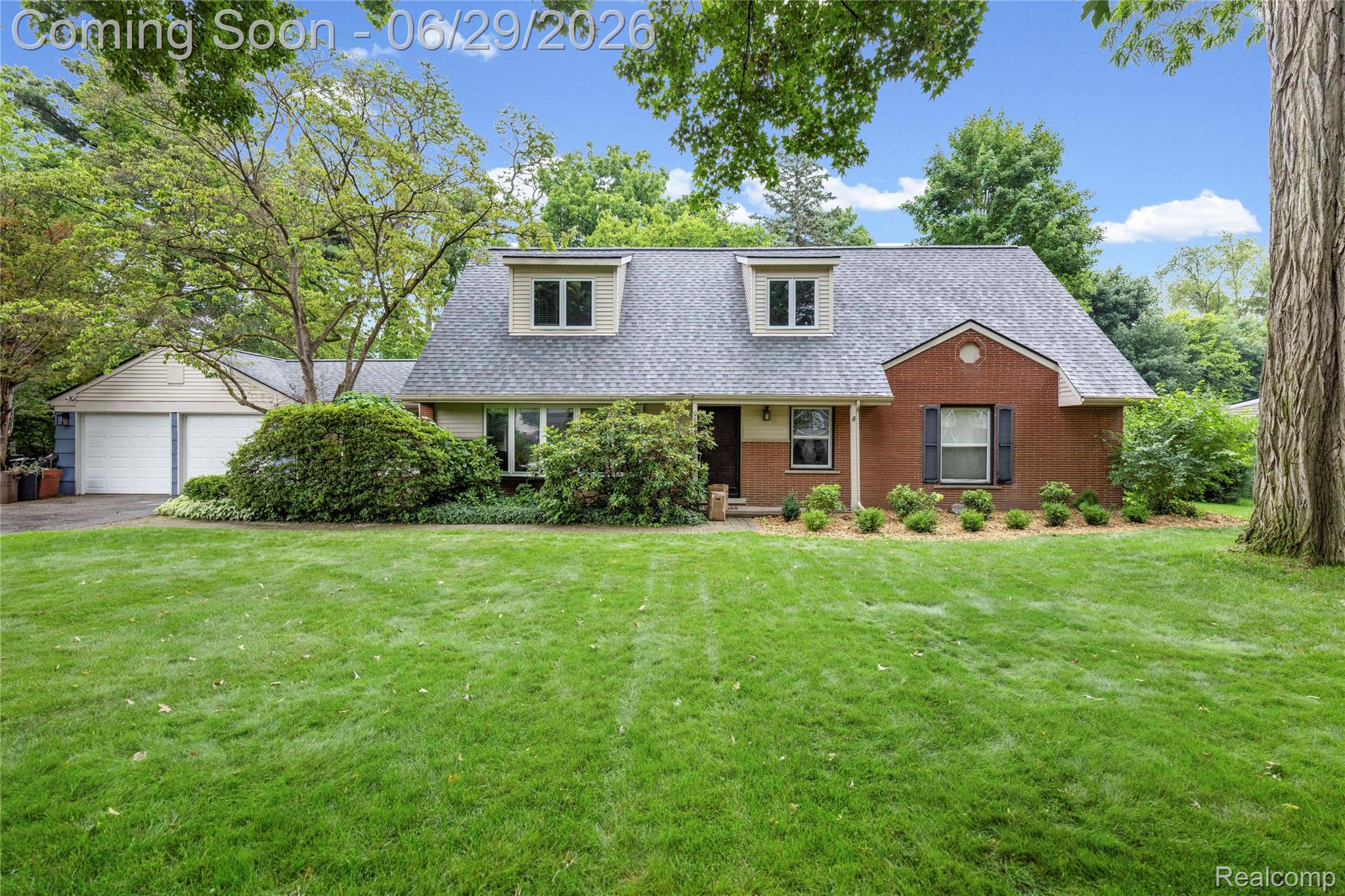 6085 Worlington Road Bloomfield Hills, MI 48301 - Photo 4 of 75 Brick and siding exterior featuring a detached two-car garage