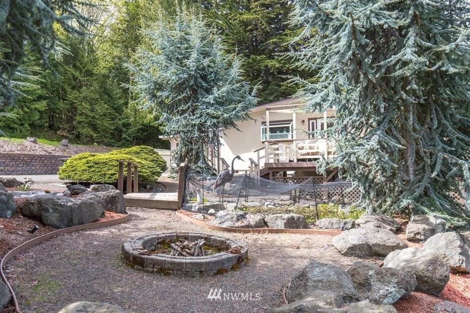 744 Miller Road Sequim, WA 98382 - Photo 11 of 40 a view of a backyard with table and chairs potted plants and large tree