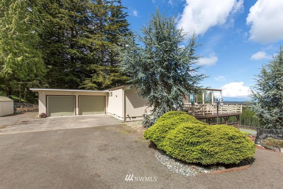 744 Miller Road Sequim, WA 98382 - Photo 12 of 40 a front view of a house with a yard and garage