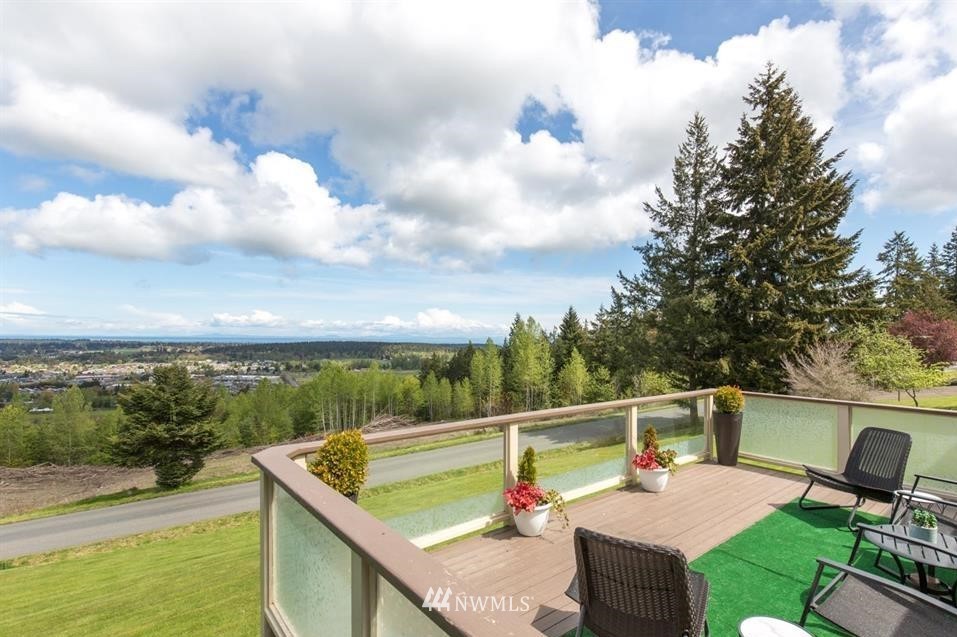 744 Miller Road Sequim, WA 98382 - Photo 14 of 40 a view of a balcony with two chairs and a table