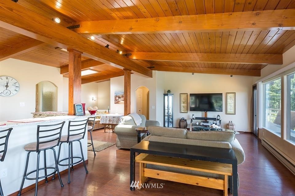 744 Miller Road Sequim, WA 98382 - Photo 18 of 40 a living room with furniture a fireplace and a flat screen tv