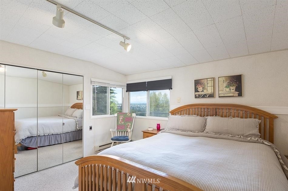 744 Miller Road Sequim, WA 98382 - Photo 23 of 40 a bedroom with a bed and large window with balcony view