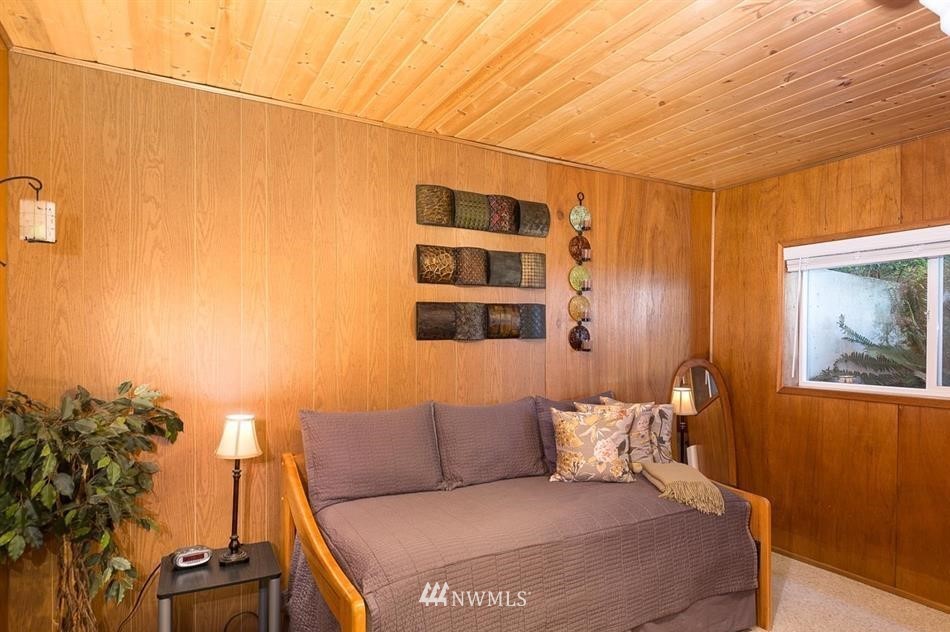 744 Miller Road Sequim, WA 98382 - Photo 33 of 40 a bedroom with a bed and a potted plant