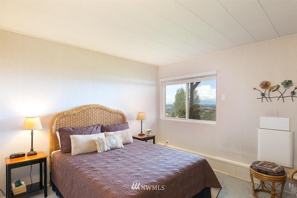 744 Miller Road Sequim, WA 98382 - Photo 34 of 40 a bedroom with a bed and a lamp with the dresser