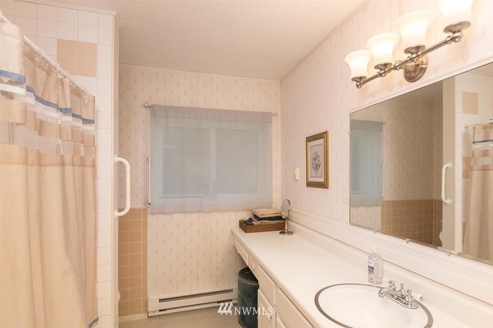 744 Miller Road Sequim, WA 98382 - Photo 35 of 40 a bathroom with a sink a mirror and a shower