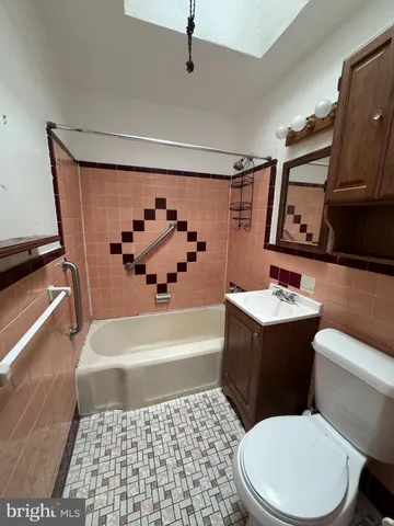 a bathroom with a sink a toilet and bathtub