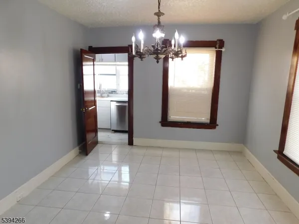 a kitchen with stainless steel appliances granite countertop a refrigerator a sink a stove and a microwave oven