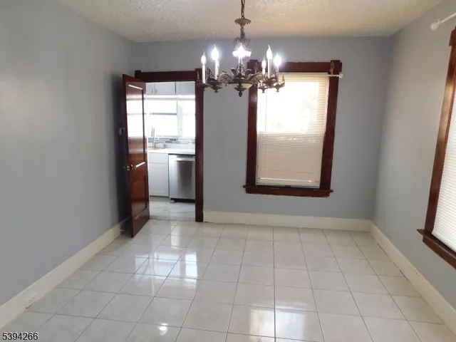 a kitchen with stainless steel appliances granite countertop a refrigerator a sink a stove and a microwave oven