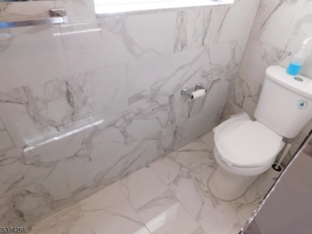 a view of bathroom with a sink and mirror