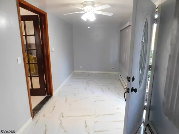 wooden floor in an empty room with a mirror