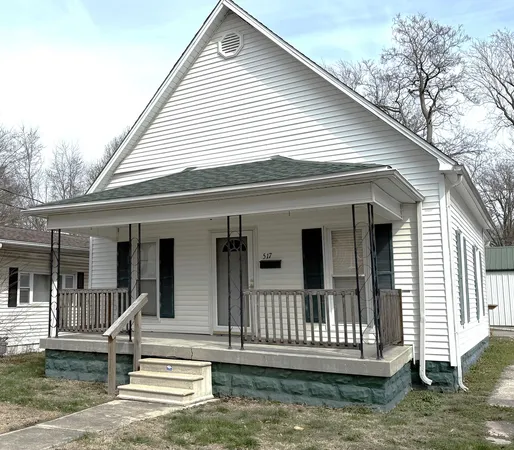 a view of a house with a small deck
