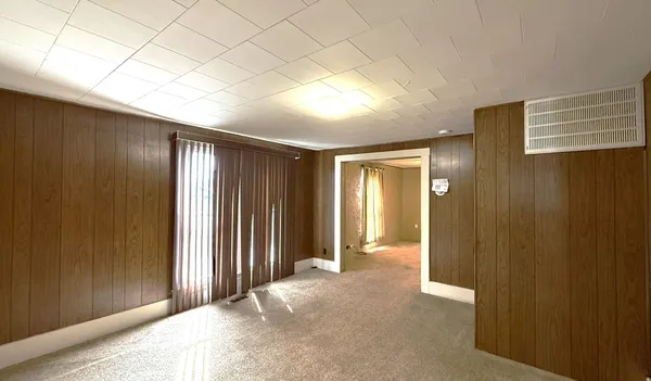 an empty room with windows and closet