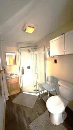 a bathroom with a granite countertop sink toilet a mirror and bathtub