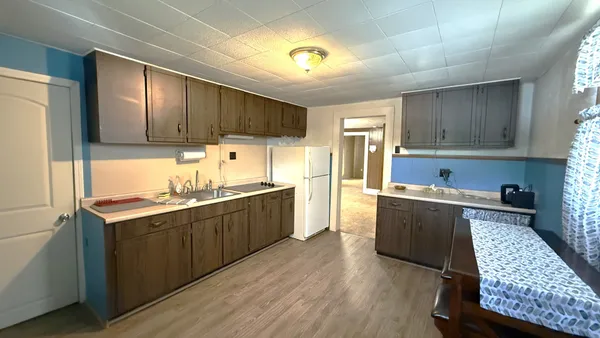 a kitchen with wooden cabinets and refrigerator