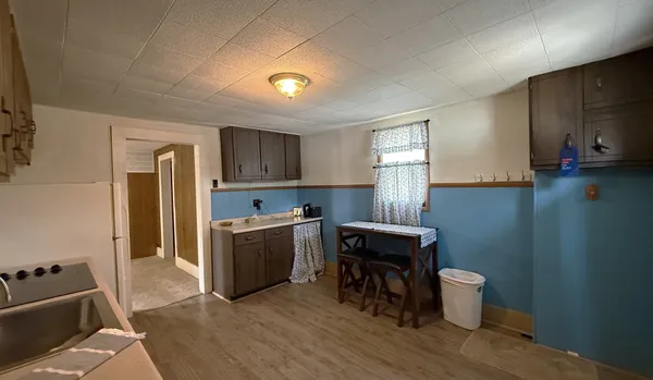 a kitchen with sink cabinets and wooden floor