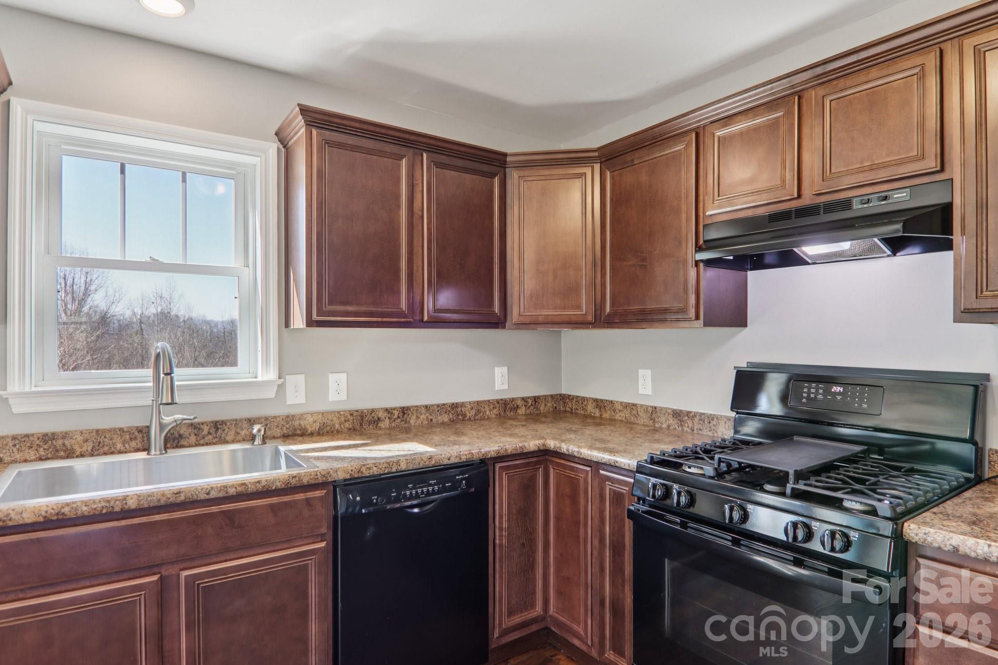 751 Hutch Mountain Road Fletcher, NC 28732 - Photo 15 of 48 a kitchen with granite countertop cabinets stove top oven and sink