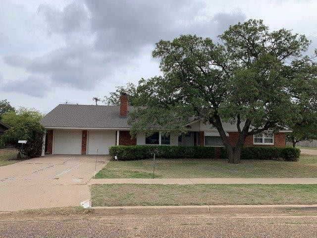 1502 Ave K Ralls, TX 79357 - Photo 1 of 23 a front view of a house with a garden and trees