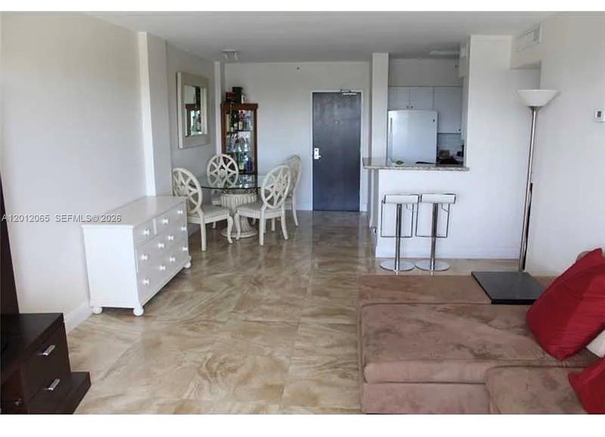 1500 Bay Road, Unit 318S Miami Beach, FL 33139 - Photo 6 of 6 a view of a livingroom with furniture & a flat screen tv