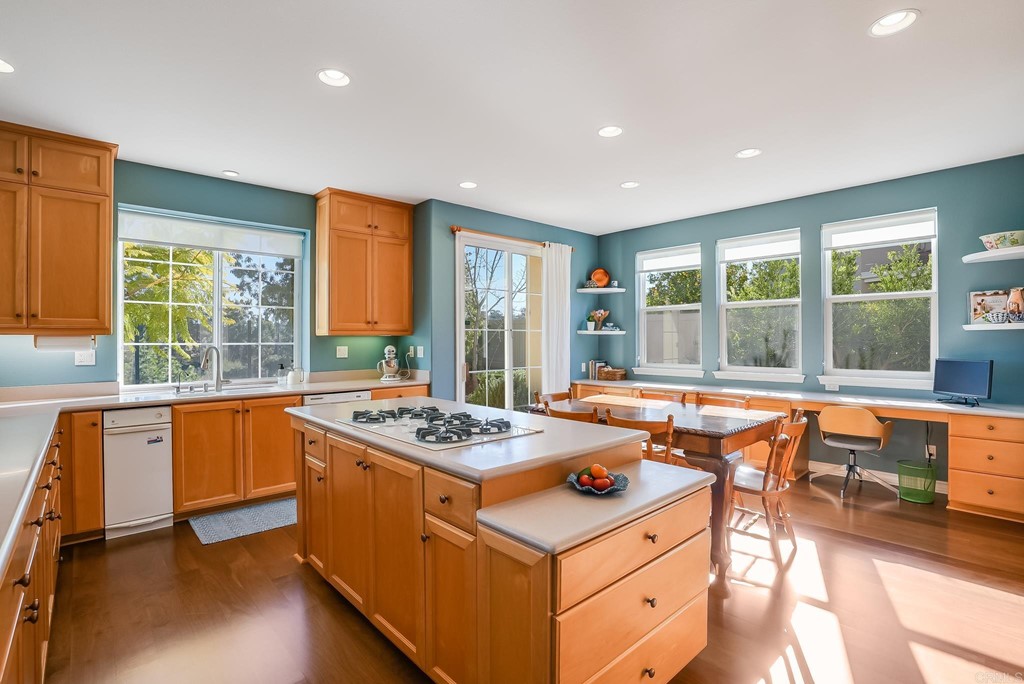 8046 Calle Pinon Carlsbad, CA 92009 - Photo 17 of 51 a table and chairs in a room with large windows