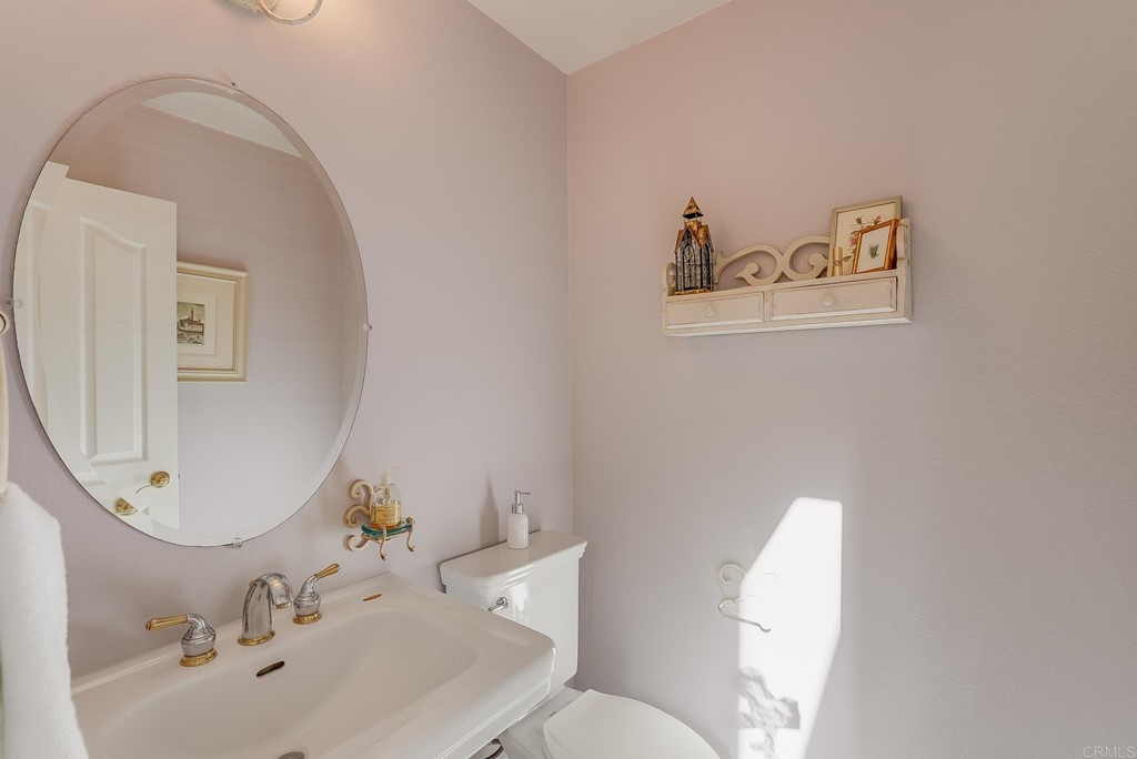 8046 Calle Pinon Carlsbad, CA 92009 - Photo 19 of 51 a bathroom with a toilet sink and mirror