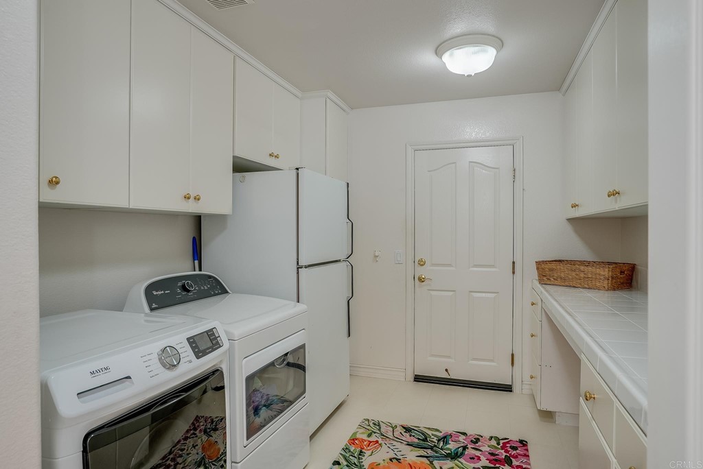 8046 Calle Pinon Carlsbad, CA 92009 - Photo 20 of 51 a view of a kitchen with fridge and wooden floor