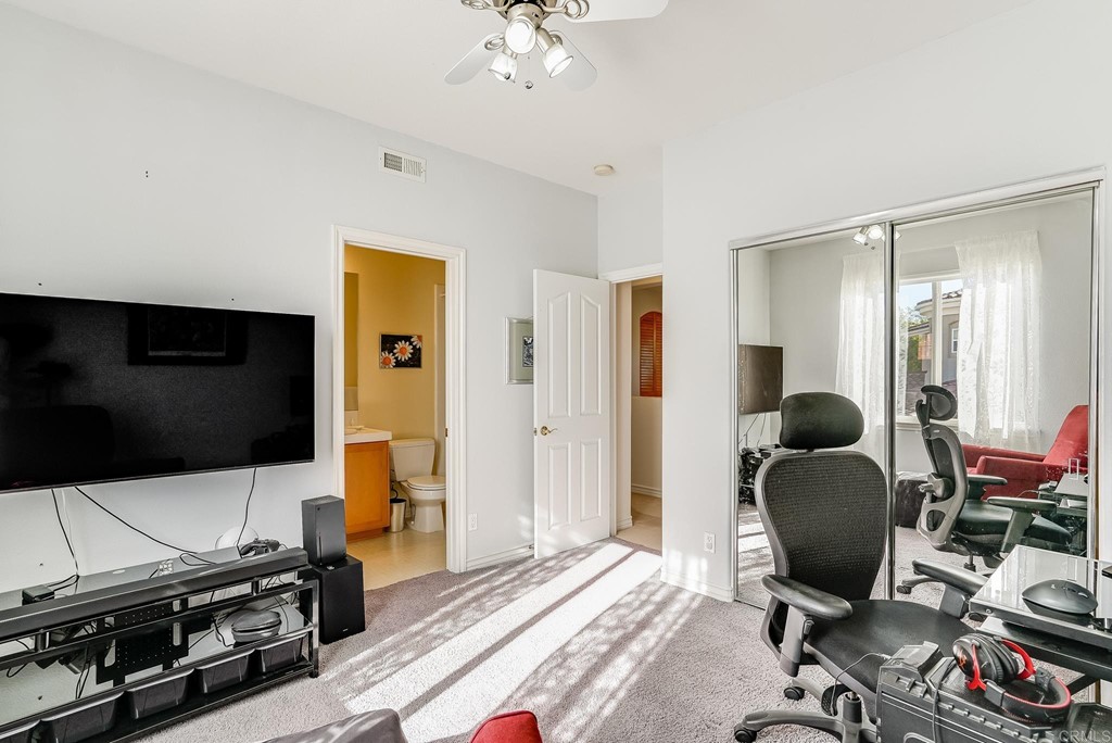 8046 Calle Pinon Carlsbad, CA 92009 - Photo 31 of 51 a workspace with a flat screen tv and gym equipment