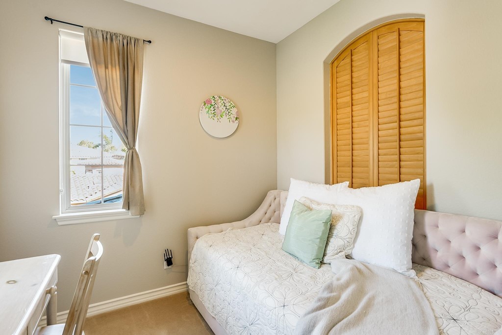 8046 Calle Pinon Carlsbad, CA 92009 - Photo 37 of 51 a bedroom with a bed and a window