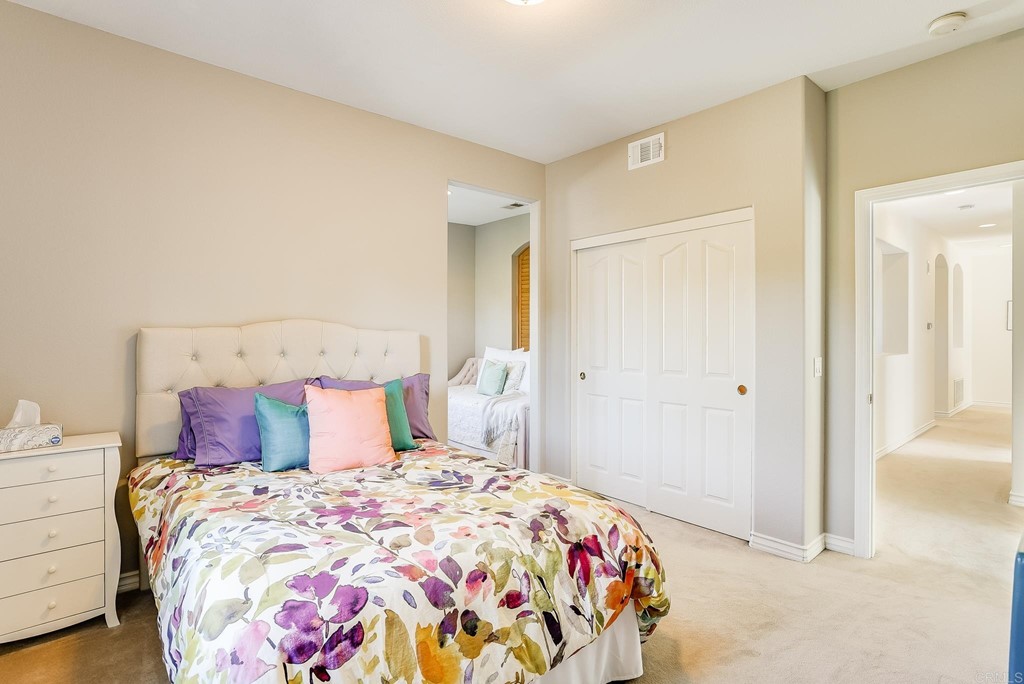 8046 Calle Pinon Carlsbad, CA 92009 - Photo 38 of 51 a bedroom with a bed and a mirror
